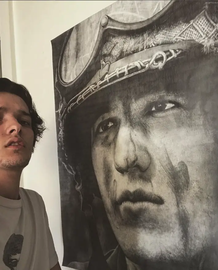 Me next to a large portrait I drew.